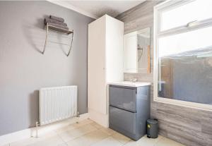 a bathroom with a sink and a window at Maidstone castle 3bedroom free sports channels, parking in Kent