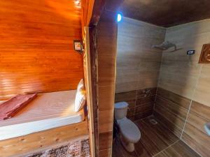 a bathroom with a bed and a shower and a toilet at Flight Mode Camp in Nuweiba