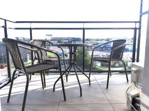 a table and chairs on a balcony with a view at Apartament Venus in Warsaw