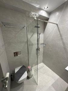 a bathroom with a glass shower with a toilet at Oikos 9 Rooms and Suites in Nafpaktos