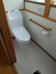 a bathroom with a white toilet in a room at 民家の一室1 Private Room in Japanese Vintage House with Tatami, Single Bed, Free Parking, Good to Travel for Tashiro Cats Island in Ishinomaki
