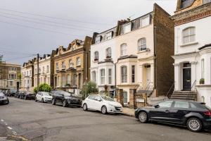 a row of cars parked in front of buildings at Contemporary Clapham Living in London