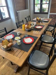 a wooden table with food on top of it at La Ressource in Fontguenand