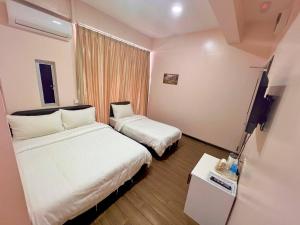 Postel nebo postele na pokoji v ubytování Sipadan Crystal Haven Inn