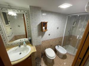 a bathroom with a sink and a toilet and a shower at Casa Antonella in Naples