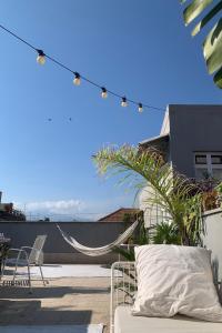 a patio with a hammock and chairs on a roof at Homestay in Catania