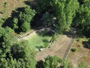 an aerial view of a park with a pond at Alluring Farmhouse in Ortignano with Swimming Pool in Castel Focognano