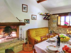 a living room with a table and a fireplace at Alluring Farmhouse in Ortignano with Swimming Pool in Castel Focognano
