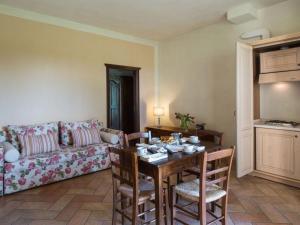 a living room with a table and a couch at Pleasant apartment in Santa Maria Degli Angeli with pool in Tordandrea