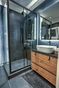 a bathroom with a sink and a shower at The Cosy luxurious Seaside Apartment in Athens +14 photos