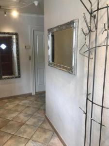a room with a mirror and a tiled floor at Den Hvide Farm in Skanderborg