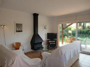 a living room with a glass table and a fireplace at Chalet la Fosca in Palamós
