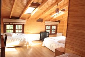 アイダー・ヤイラシにあるAyder Umit Hotelの木製の壁のベッドルーム1室(ベッド2台付)