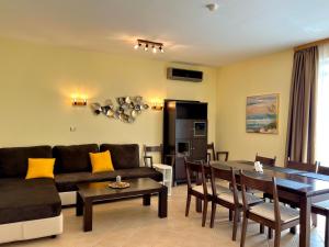 a living room with a couch and a table at Premium Apartment Midia Beach in Sunny Beach