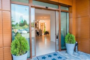 an entrance to a building with two potted plants at St. Panteleimon Beach Hotel in Nesebar