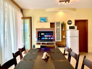 a dining room with a table and a refrigerator at Premium Apartment Midia Beach in Sunny Beach