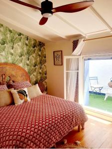 a bedroom with a bed and a ceiling fan at La Beytina - B&B and Apartment in Pennautier