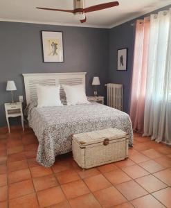 a bedroom with a bed and two tables and two windows at La Beytina - B&B and Apartment in Pennautier