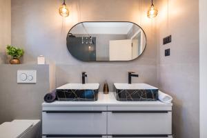 a bathroom with two sinks and a mirror at Holiday house Vito Zadar in Zadar +37 photos