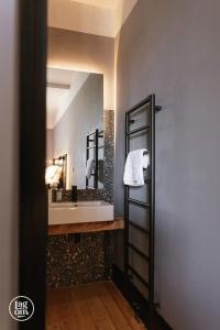 a bathroom with a sink and a mirror at StayLagom in Ballycastle