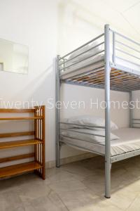 a couple of bunk beds in a room at Twenty Seven HomeStay in Cheras