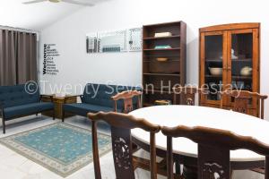 a living room with a table and chairs at Twenty Seven HomeStay in Cheras