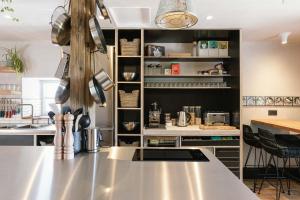 a kitchen with a stainless steel counter and a counter top at StayLagom in Ballycastle
