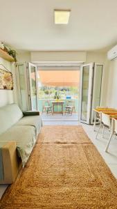 a bedroom with a bed and a table and chairs at Silvy's Sunny House in Platamona