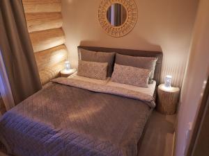 a small bedroom with a bed and a mirror at Ferienhaus Wiesenchalet im Sauerland in Schalksmühle