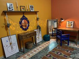 a living room with a desk and a table and a table at Medusa Home Stay in Amman