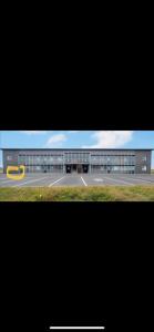 a large building with a yellow circle in front of it at Beautiful apartment near Airport in Njarðvík