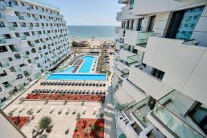 an aerial view of a building with a pool and the ocean at MDApartment in Infinity Beach Resort- Parking in Mamaia