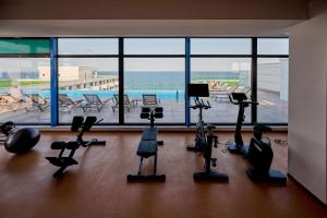 a gym with exercise equipment and a large window at MDApartment in Infinity Beach Resort- Parking in Mamaia