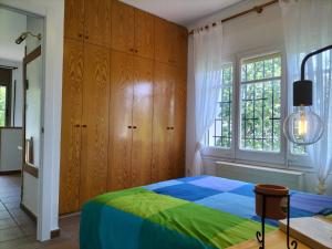 a bedroom with a bed and a window at Casa Flor de Taronger in Viladecáns