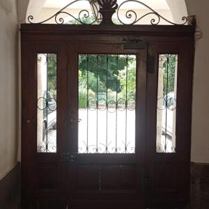 a wooden door with two windows in a building at casavera in Como