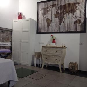 a room with a dresser and a map on the wall at casavera in Como +10 photos