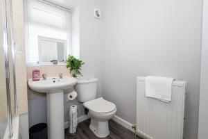a white bathroom with a toilet and a sink at Free Parking Leisure Contractor Central in Rishton