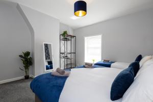 a bedroom with a large bed with blue pillows at Free Parking Leisure Contractor Central in Rishton