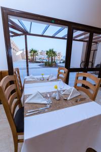een tafel met witte tafels en stoelen met uitzicht bij Sky View Suites Hotel in Hurghada