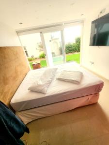 ein großes Bett in einem Zimmer mit einem großen Fenster in der Unterkunft Playa bonita in Estepona