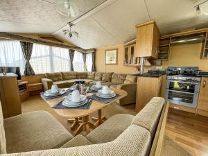 a kitchen and a living room with a table and chairs at Lovely Caravan By The Beach In Pakefield, Suffolk Ref 68007cl in Lowestoft