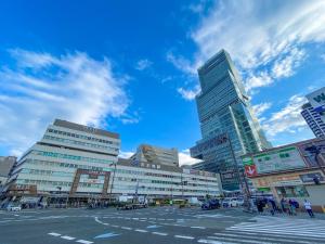 a city street with tall buildings and a blue sky at Hotel Bali Tower Osaka Tennoji in Osaka