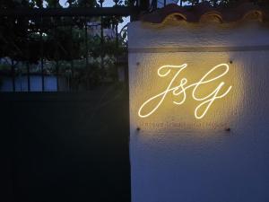 una señal encendida en una pared blanca en Unique Traditional House, hosted by J&G en Tirana