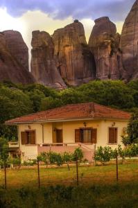 a house in front of a mountain at Genesis in Kastraki