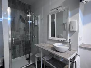 a bathroom with a sink and a shower at HOSTAL CASA JULIO - Auto Check-in in Culleredo +22 photos