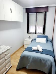 a bedroom with a bed with two towels on it at El mirador de la torre in Potes
