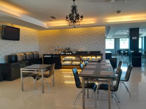 a dining room with two tables and chairs at Hotel De Leon in Lahad Datu