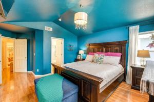 a blue bedroom with a bed and a blue wall at Sacramento Home with Fire Pit 15 Mi to Downtown! in Sacramento