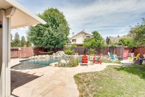 a backyard with a pool with chairs and a fence at Sacramento Home with Fire Pit 15 Mi to Downtown! in Sacramento