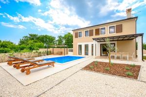 a home with a swimming pool and a house at Villa Laura Mia by IstriaLux in Juršići